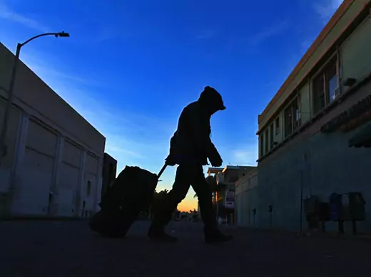 A homeless man makes his way down the street before sunrise (Mike Blake/Courtesy Reuters).