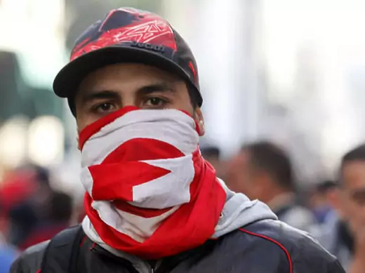 A protester wears a Tunisian flag during a demonstration in Tunis February 7, 2013 (Larbi/Courtesy Reuters).