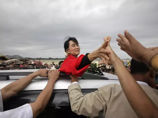 Myanmar pro-democracy leader Suu Kyi shakes hands with supporters after giving a speech in Monywa, Myanmar.