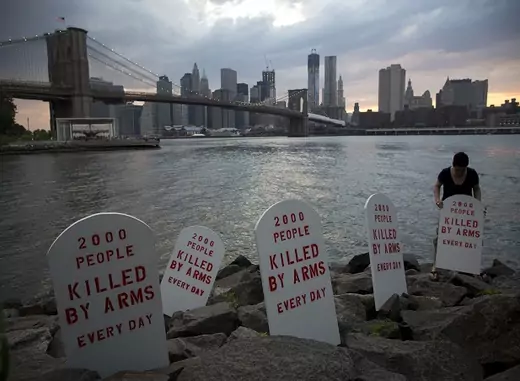 Fake tombstones are placed along the East River by members of the Control Arms Coalition to coincide with a diplomatic conference on the future Arms Trade Treaty in New York