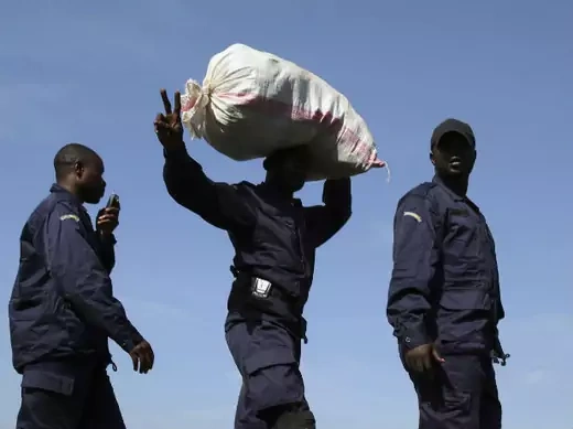 A newly deployed police officer gestures as he walks in a line in Goma port December 2, 2012.