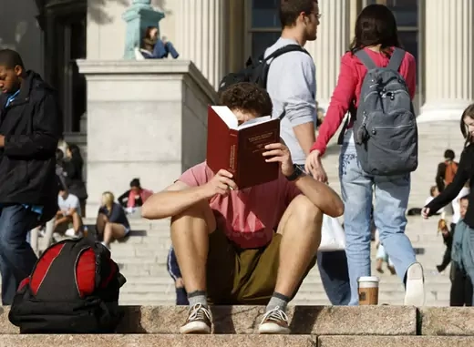 A student reads on the campus of Columbia University in New York (Mike Segar/Courtesy Reuters).
