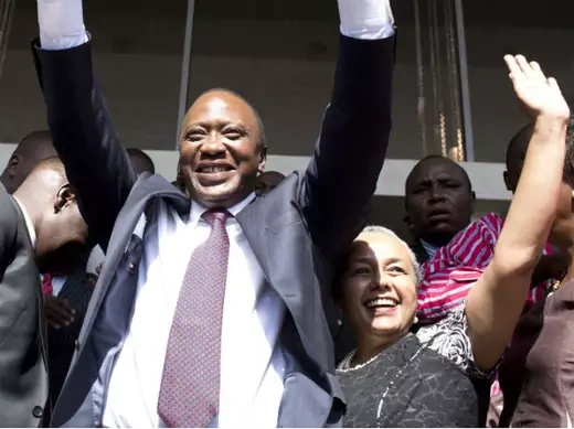 President-elect Uhuru Kenyatta greets his supporters in the company of his wife Margaret, soon after attending a news conference in Nairobi March 9, 2013.
