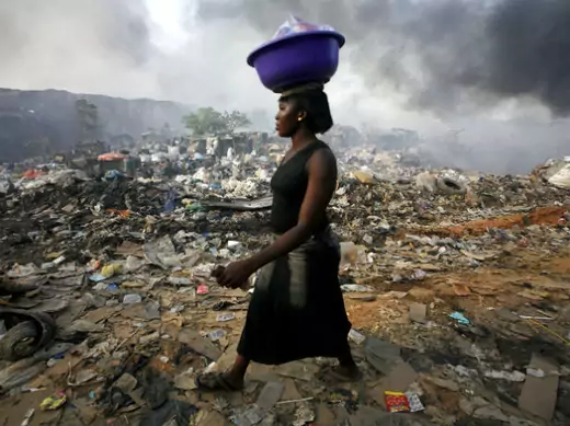 Lagos, Nigeria A woman walks through Olusosun rubbish dump in Nigeria's commercial capital Lagos April 18, 2007.
