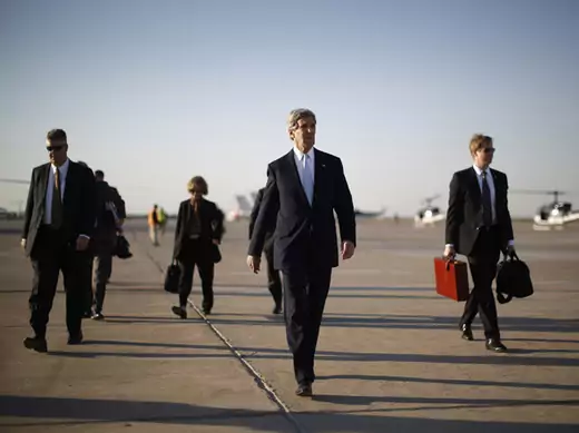Secretary of State John Kerry walks across the tarmac of Baghdad International Airport on a March visit to Iraq (Jason Reed/Courtesy Reuters). 