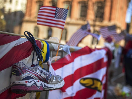 A jogging shoe hangs at a makeshift memorial for the victims of the Boston Marathon bombings on Boylston Street (Shannon Stapleton/Courtesy Reuters).