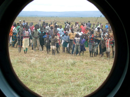 Congolese children in Mitwaba camp for internally displaced people watch as a U.N. helicopter lifts off after delivering emergency food aid in Katanga Province, eastern Democratic Republic of Congo February 9, 2006.