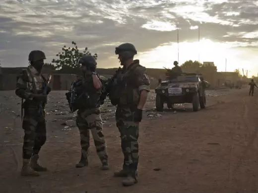 French soldiers speak to a Nigerian soldier on patrol in the northern city of Gao, Mali February 9, 2013. 