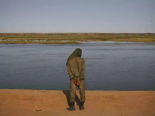 A Malian soldier looks out on the banks of the Niger River in Gao February 26, 2013.