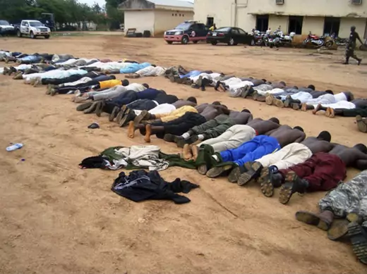 BAUCHI, Nigeria Members of an local Islamic group lie on the ground at a police station after their arrest in the northeastern city of Bauchi, July 25, 2009.