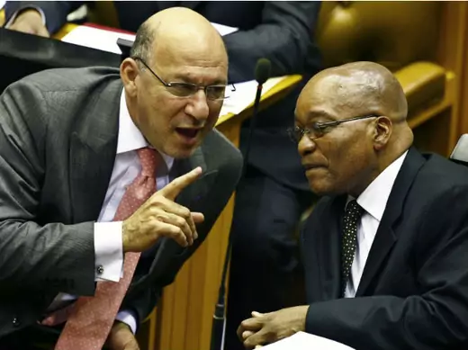 South Africa's Finance Minister Trevor Manuel chats with ruling African National Congress President Jacob Zuma in Parliament in Cape Town during the swearing in of members and the formal election of the country's president, May 6, 2009.