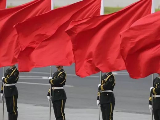Members of the People's Liberation Army guard of honour stand with red flags during an official welcome ceremony outside the Great Hall of the People, in Beijing on April 15, 2013. (Courtesy Reuters/Jason Lee) 