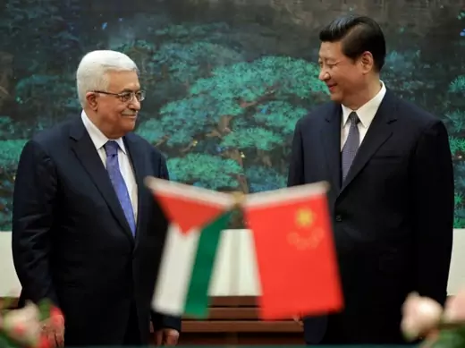 China's President Xi Jinping (R) and his Palestinian counterpart Mahmoud Abbas smile at each other during a signing ceremony at the Great Hall of the People in Beijing on May 6, 2013. (Courtesy Reuters/Jason Lee)