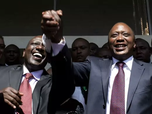 President-elect Uhuru Kenyatta (R) greets his supporters with his running mate, former cabinet minister William Ruto after attending a news conference in Nairobi March 9, 2013.