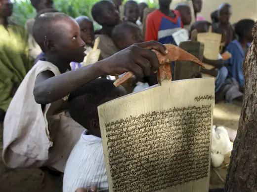 Children recite verses from the Koran outside a Koranic school in Bichi village, on the outskirt of Nigeria's northern city of Kano July 25, 2012. 