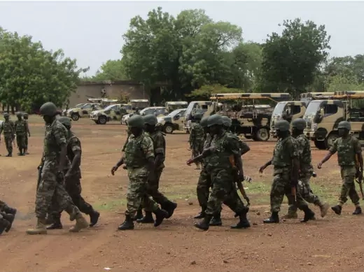 Soldiers from Lagos, part of an expected 1,000 reinforcements sent to Adamawa state to fight Boko Haram Islamists, walk near trucks as they arrive with the 23rd Armoured Brigade in Yola May 20, 2013.