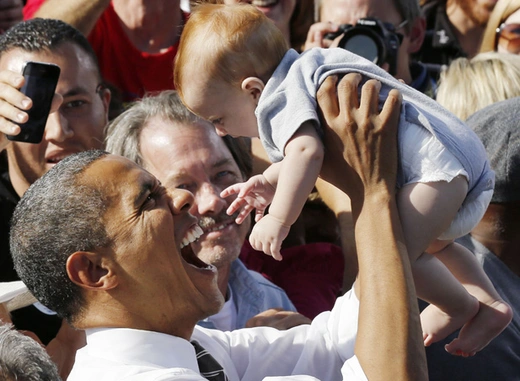 President Obama holds up a baby after speaking in Las Vegas (Larry Downing/Courtesy Reuters).
