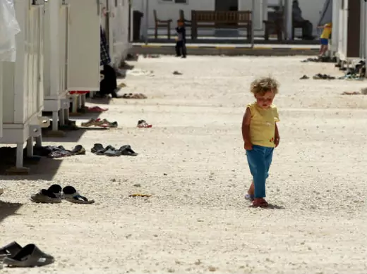 A Syrian refugee girl walks inside the Mrajeeb Al Fhood refugee camp, 20 km (12.4 miles) east of the city of Zarqa April 29, 2013 (Hamed/Courtesy Reuters)..