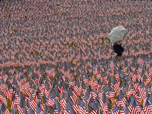 A pedestrian walks through a Memorial Day display of American flags on the Boston Common (Brian Snyder/Courtesy Reuters).