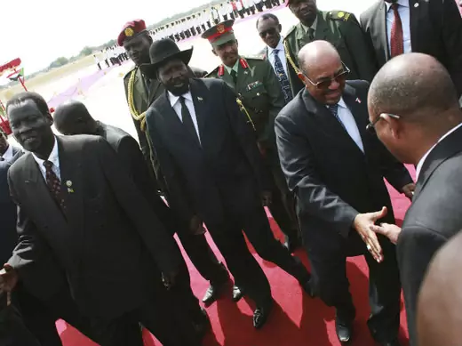 Sudan's President Omar Hassan al-Bashir (2nd R) meets officials from the Government of South Sudan (GOSS) near his South Sudan counterpart Salva Kiir (C) upon his arrival at the Juba Airport in South Sudan April 12, 2013.