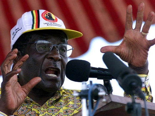 Zimbabwean President Robert Mugabe arrives at a rally to address
