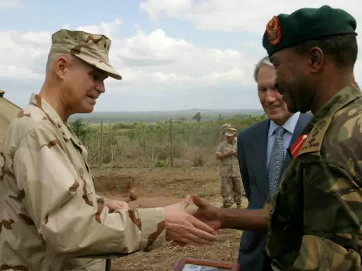 The Commander of Combined Joint Task Force-Horn of Africa Real Admiral Richard Hunt (L) meets Tanzania Peoples Defence Forces (TPDF), Director of Training, Col. Charles Jitenga (R) during the opening Msata dispensary in Bagamoyo, 120km (75 miles) northwest of Dar es Salaam, August 17, 2006.