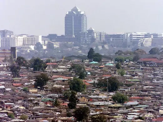 General view of Alexandra township, commonly known as Alex, a slum overlooking the Sandton sky scrappers in Johannesburg August 23, 2002.