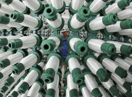 An employee works at a textile mill in Jiujiang, Jiangxi province, China on March 28, 2013. China's factory activity likely expanded at its fastest rate in 11 months in March 2013, with an anticipated pick-up in both domestic and external demand set to bolster the case that its economic recovery is gathering pace, not simply stabilizing. 
