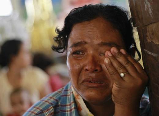 A Muslim woman cries in a monastery used to shelter internally displaced people after a riot between Muslims and Buddhists in Lashio township on May 30, 2013. 