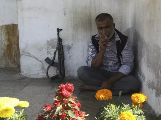 A Free Syrian Army fighter smokes a cigarette during his break near the frontline in the Al-Sakhour neighborhood of Aleppo, June 21, 2013 (Salman/Courtesy Reuters).