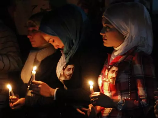 Women hold candles as they mourn at a funeral earlier this week in Raqqa province east of Syria May 16, 2013 (Kelze/Courtesy Reuters).