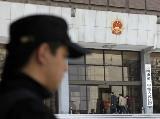 A security personnel stands guard at the Shanghai's No. 1 People's Intermediate Court.