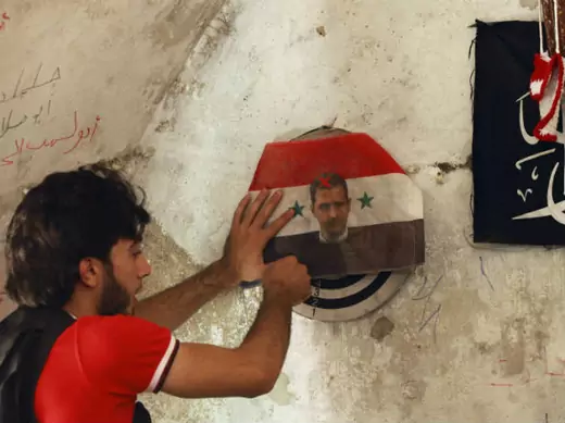 A member of the Free Syrian Army plays darts on a picture of Syrian President Bashar al-Assad in the Bab al-Nasr neighborhood of Aleppo June 28, 2013 (Khatib/Courtesy Reuters).