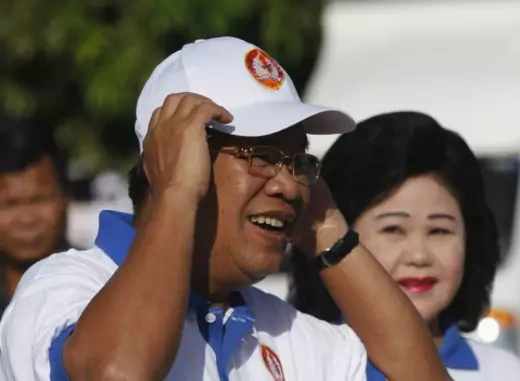 Cambodia's Prime Minister Hun Sen and his wife Bun Rany (R) arrive at an election campaign area in Phnom Penh on June 27, 2013. (Pring Samrang/Courtesy Reuters)