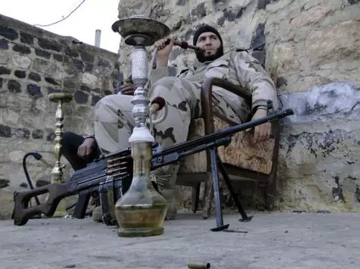 Free Syrian Army fighters smoke waterpipes near the Menagh military airport, in Aleppo's countryside January 25, 2013 (Hassano/Courtesy Reuters).. 