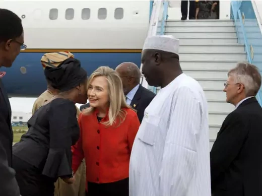 Nigeria's Minister of State for Foreign Affairs Viola Onwuliri (2nd L) greets U.S. Secretary of State Hillary Clinton as she arrives at Abuja International Airport in Abuja August 9, 2012.
