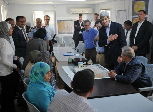 U.S. Secretary of State John Kerry greets Syrian refugees