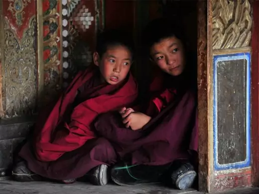 Young Tibetan monks chat during a prayer meeting for tourists at a temple in Huangnan Tibetan Autonomous Prefecture, Qinghai province on July 19, 2012.