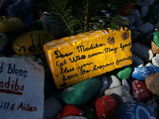 A get-well message is seen on a brick outside former South African president Nelson Mandela's garden in Houghton, Johannesburg August 31, 2013.