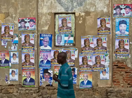 A man walks past election campaign posters in Kano, northern Nigeria, April 1, 2011.