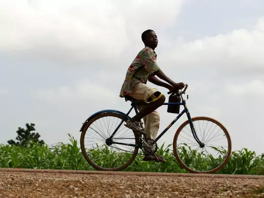 A youth rides past a bicycle along Anka-Sokoto road in northeastern state of Zamfara August 13, 2013.