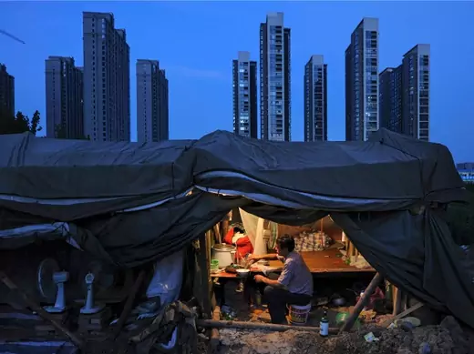 A labourer has his dinner under his shed at a construction site of a residential complex in Hefei, Anhui province, August 1, 2012. (Stringer/Courtesy Reuters)