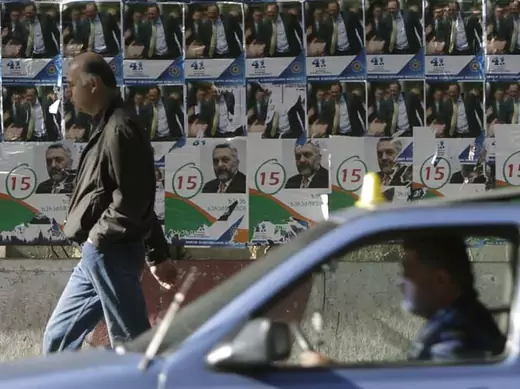 A man passes campaign posters in Tbilisi, Georgia (David Mdzinarishvili/Courtesy Reuters).
