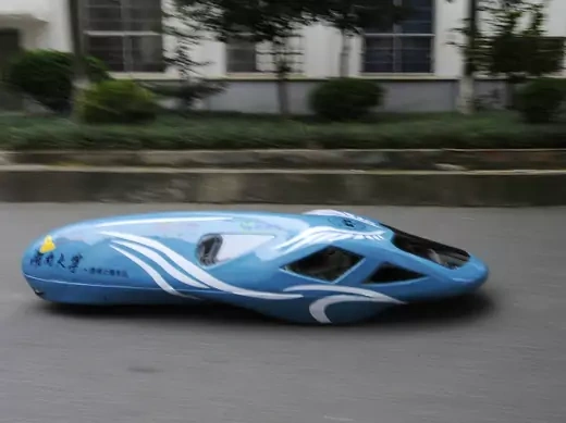 A newly-made fuel-efficient vehicle travels along a street inside the Hunan University during a test drive in Changsha, Hunan province October 8, 2013.