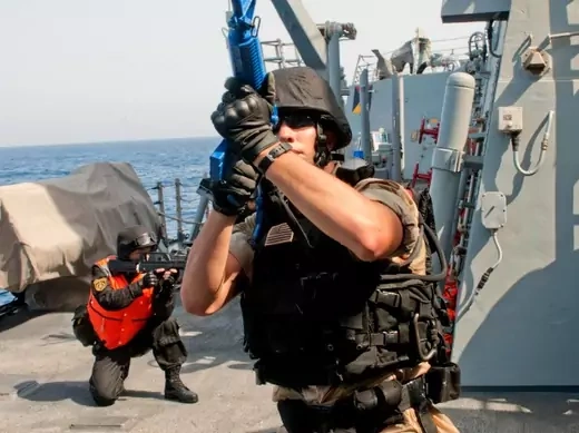 A visit, board, search and seizure member checks his surroundings aboard the guided-missile destroyer USS Winston S. Churchill during a bilateral anti-piracy exercise with the Chinese People's Liberation Army (Navy) frigate Yi Yang in the Gulf of Aden on September 17, 2012 (U.S. Navy/Mass Communication Specialist 2nd Class Aaron Chase/Courtesy Reuters).