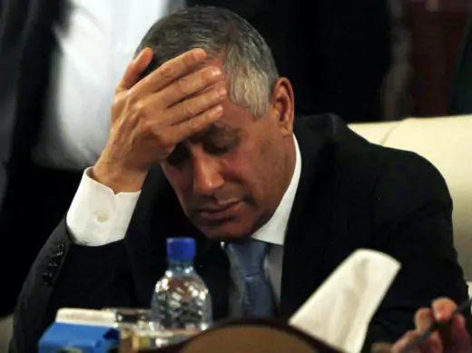 Libya's prime minister Ali Zeidan places his hand on his forehead as he addresses a news conference after his release and arrival at the headquarters of the prime minister's Office in Tripoli October 10, 2013 (Zitouny/Courtesy Reuters).