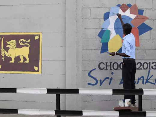 A man paints the logo of CHOGM 2013, ahead of the upcoming Commonwealth Heads of Government Meeting (CHOGM) 2013, in Colombo