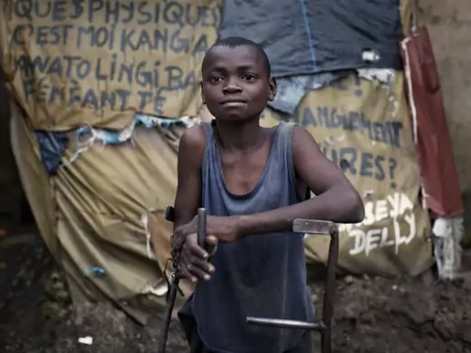 Arnaud Bivilia, 12, who suffers from polio, stands at the Stand Proud compound in Kinshasa November 29, 2011.