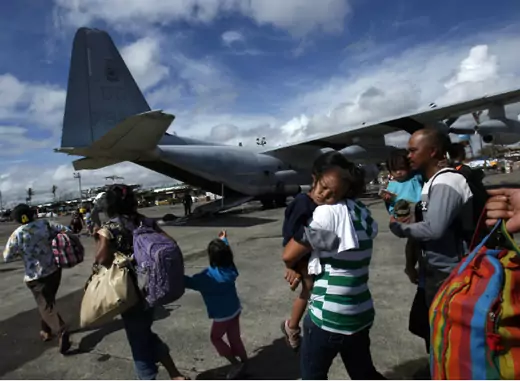 Evacuated residents prepare to get onto a U.S. military plane at Tacloban airport in central Philippines on November 13, 2013, five days after Typhoon Haiyan devastated the area. (Bobby Yip/Courtesy Reuters) 