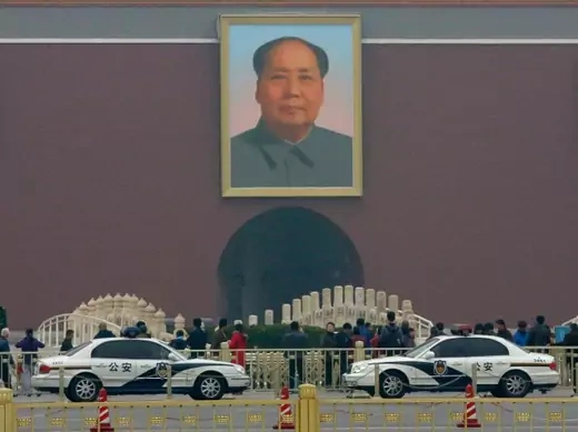 Police cars are parked in front of a giant portrait of late Chinese Chairman Mao Zedong at the main entrance of the Forbidden City in Beijing on November 1, 2013 (Kim Kyung-Hoon). 